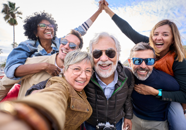 a group of friends mixed race and age take a selfie